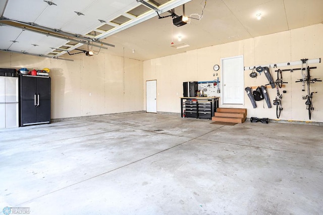 garage featuring a garage door opener and a workshop area