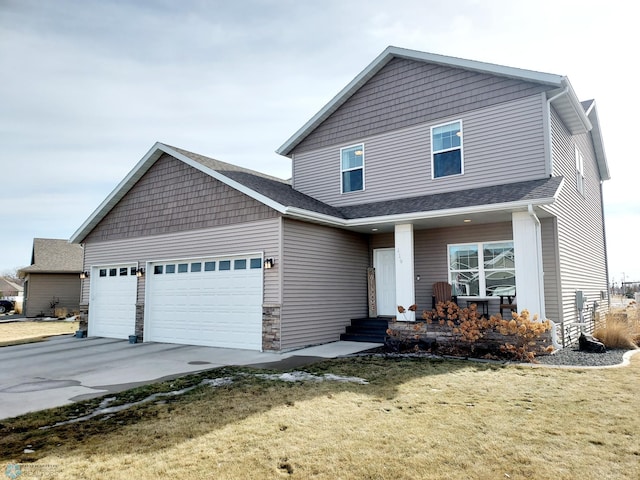 view of front of home with concrete driveway, a garage, stone siding, and a front lawn