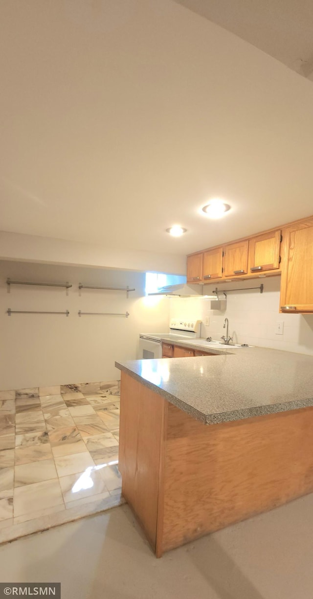 kitchen with white range with electric stovetop, kitchen peninsula, light brown cabinets, and sink