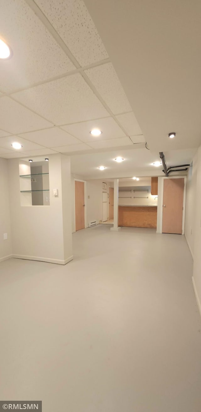 basement featuring carpet and a drop ceiling