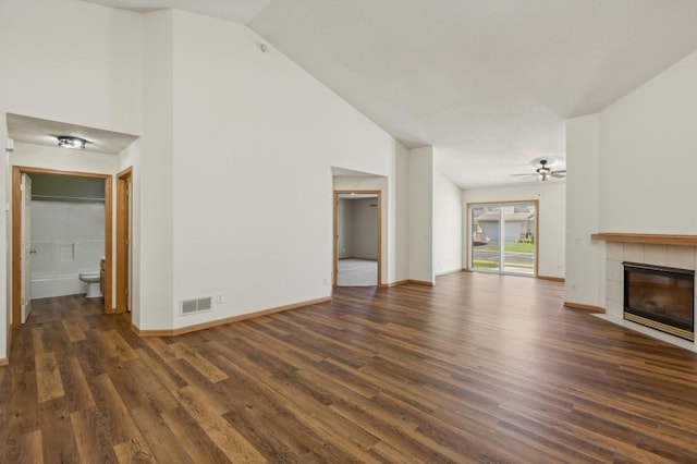 unfurnished living room with ceiling fan, dark hardwood / wood-style flooring, high vaulted ceiling, and a fireplace