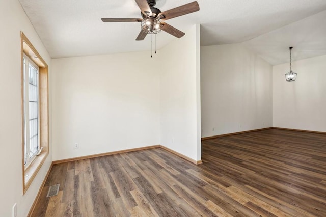 empty room featuring ceiling fan, lofted ceiling, and dark hardwood / wood-style floors