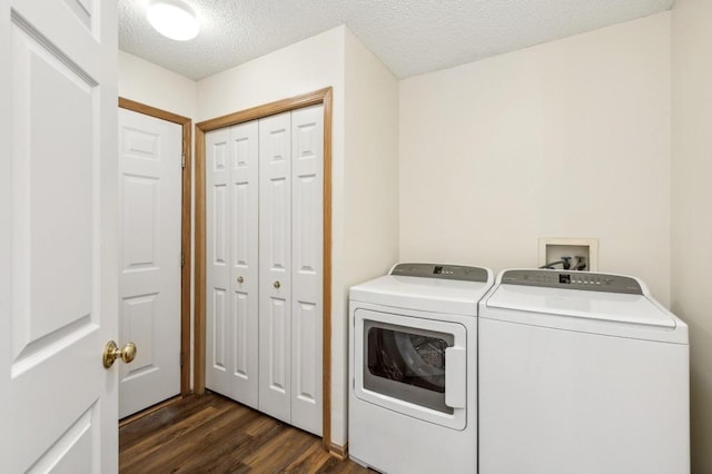 laundry room with dark wood-type flooring, separate washer and dryer, and a textured ceiling