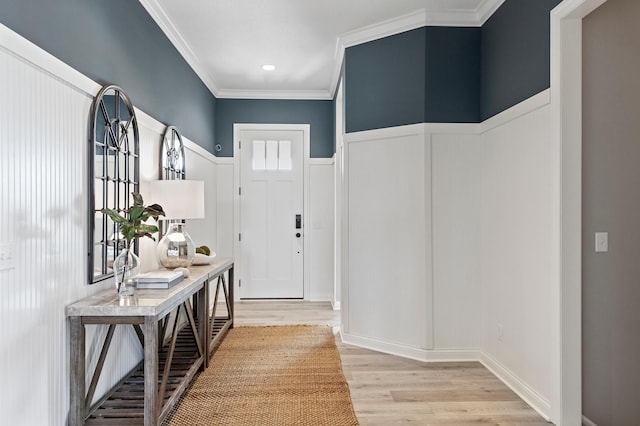 doorway to outside with light wood-type flooring and crown molding