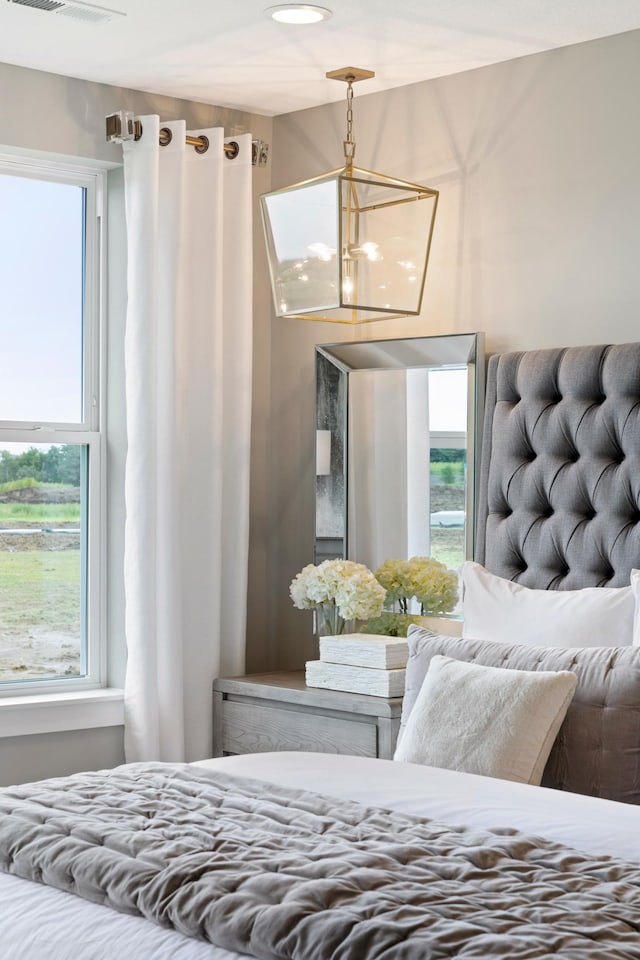 bedroom featuring a notable chandelier