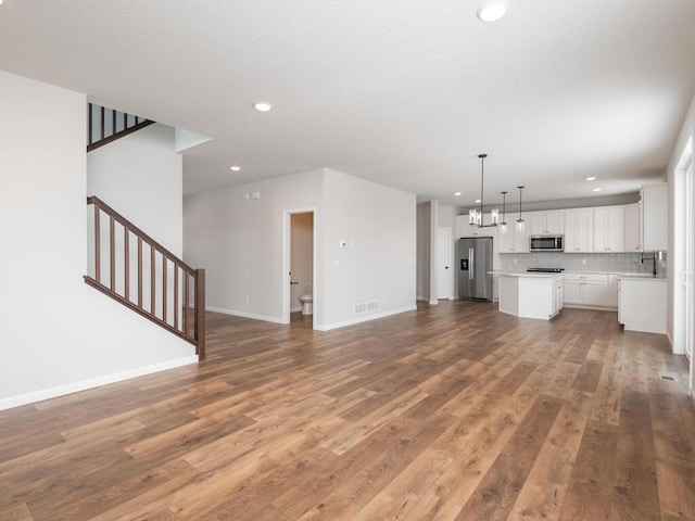 unfurnished living room with wood-type flooring