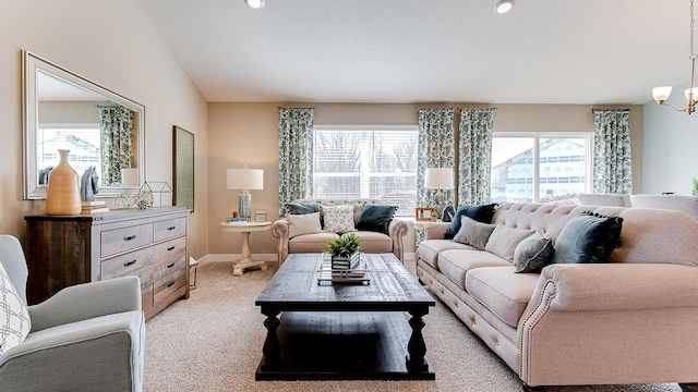 carpeted living room with an inviting chandelier, a healthy amount of sunlight, and a textured ceiling