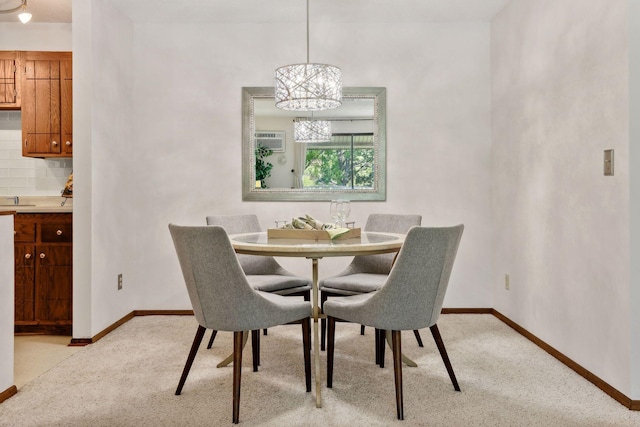 carpeted dining room with a chandelier