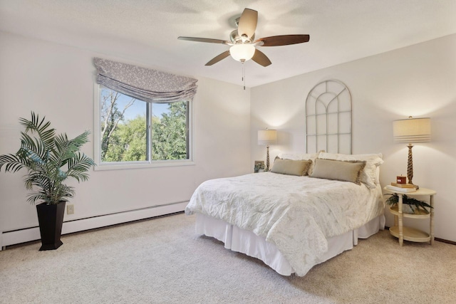 carpeted bedroom with ceiling fan and a baseboard radiator