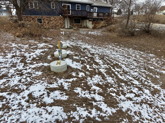 yard covered in snow with a deck