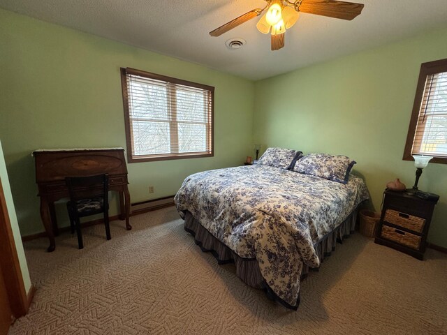 bedroom featuring ceiling fan and carpet