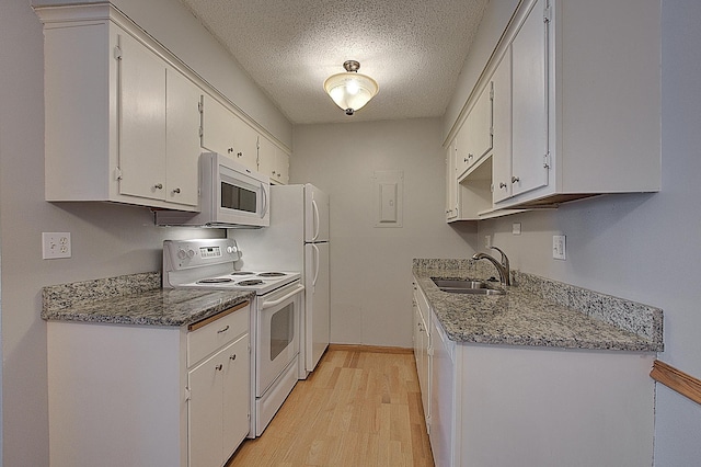 kitchen with white cabinetry, sink, light wood-type flooring, white appliances, and a textured ceiling