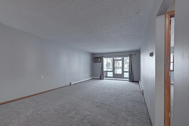 unfurnished room with carpet floors, a wall mounted air conditioner, a textured ceiling, and baseboard heating