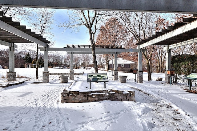 snowy yard featuring a pergola