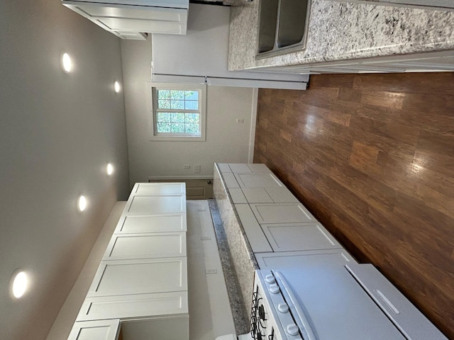 kitchen with tile countertops and white cabinets