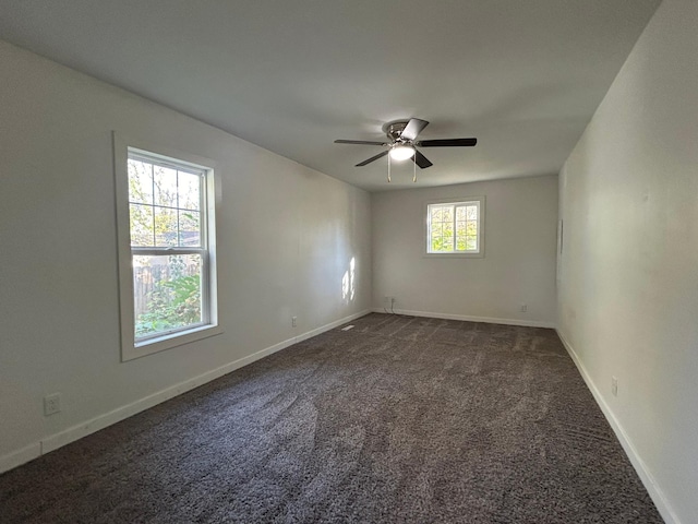 carpeted spare room featuring ceiling fan