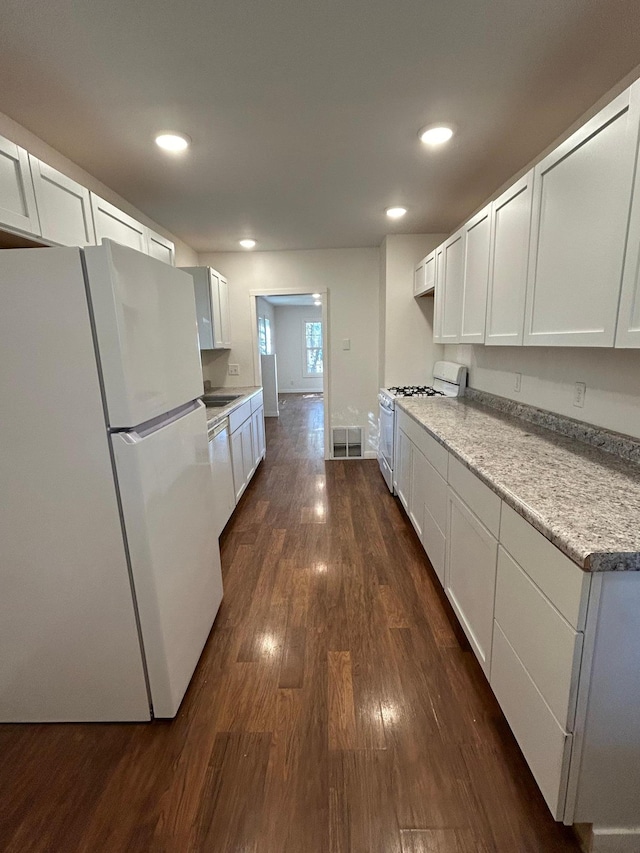 kitchen featuring recessed lighting, white appliances, visible vents, white cabinetry, and dark wood-style floors