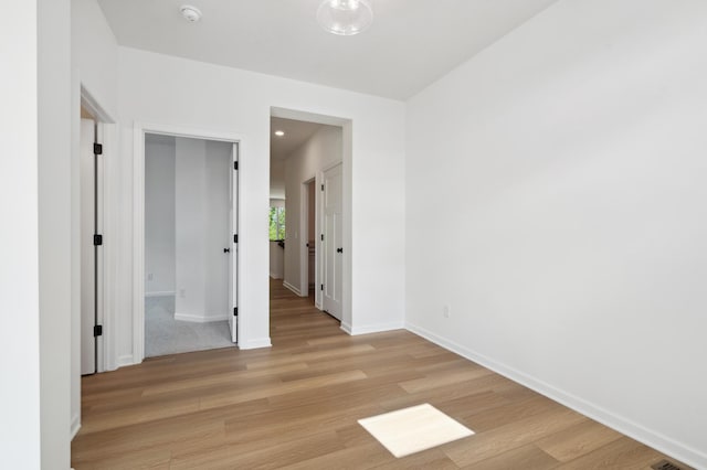 spare room with light wood-type flooring