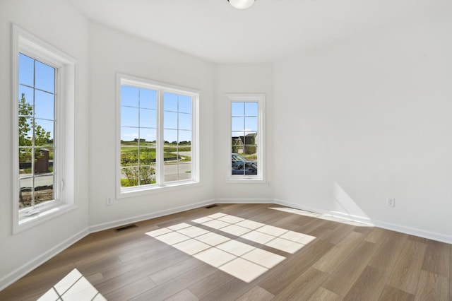 empty room with light hardwood / wood-style floors