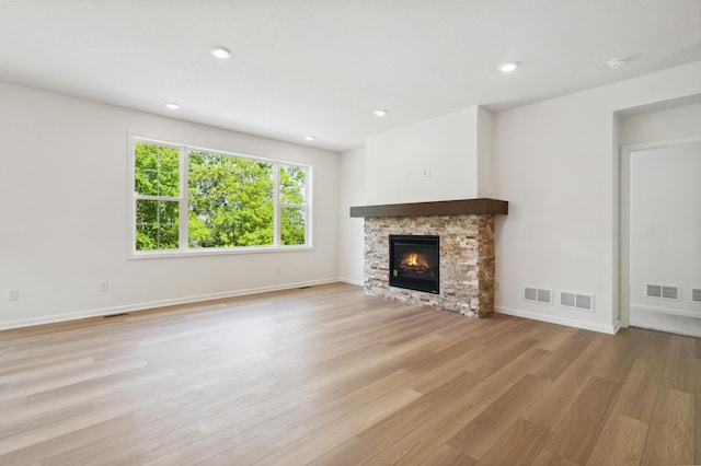 unfurnished living room featuring light hardwood / wood-style floors and a fireplace