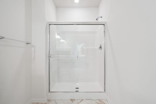 bathroom with a shower with door