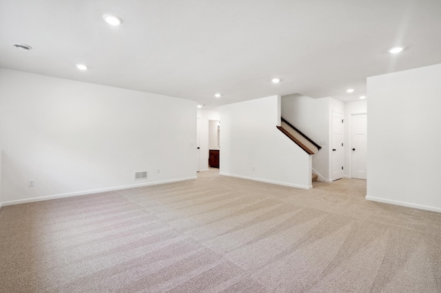 unfurnished living room with light colored carpet