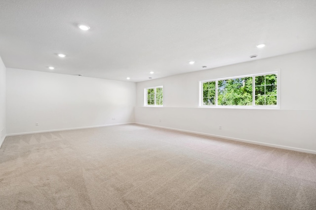 spare room featuring light colored carpet