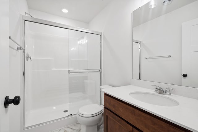 bathroom with a shower with door, toilet, and vanity