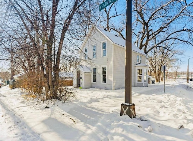 view of snow covered back of property