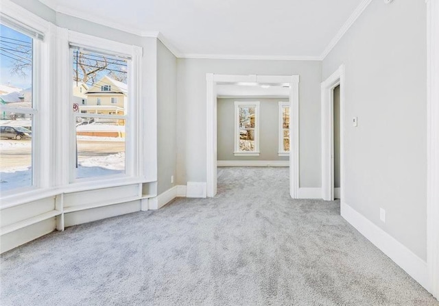 carpeted empty room with plenty of natural light and ornamental molding