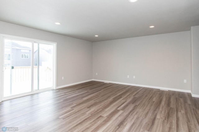 unfurnished room with wood-type flooring