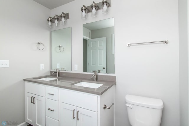 bathroom featuring toilet and vanity