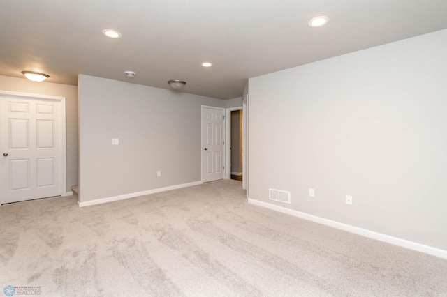 unfurnished room featuring light colored carpet