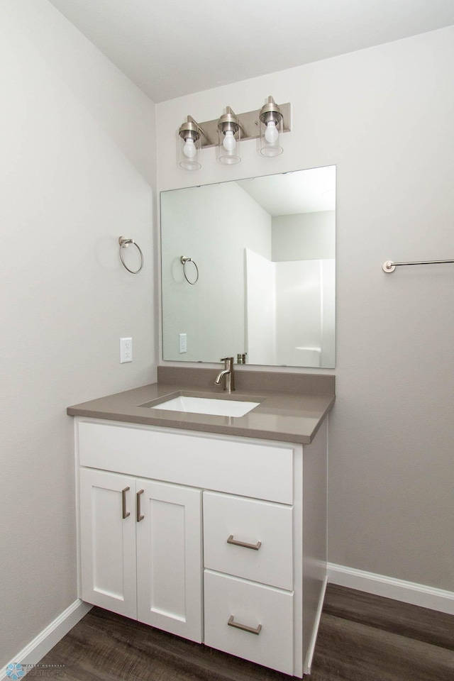 bathroom with hardwood / wood-style floors and vanity