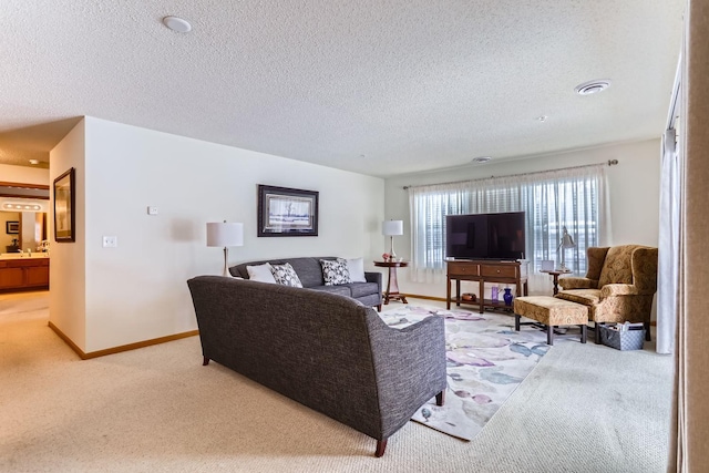 living room with a textured ceiling and light colored carpet