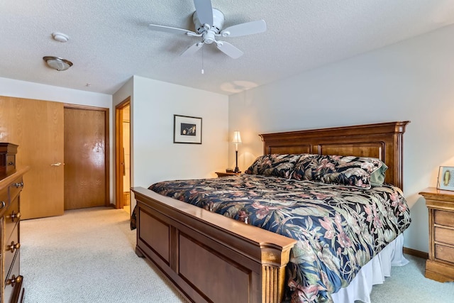 carpeted bedroom with a textured ceiling and ceiling fan