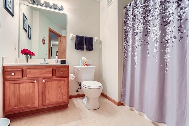 bathroom featuring toilet, tile patterned floors, and vanity