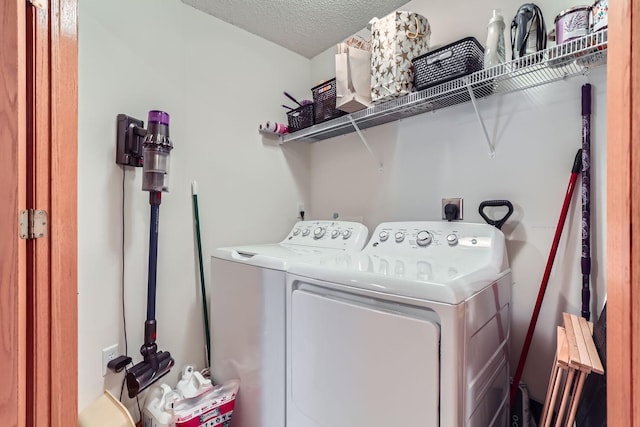 laundry area with a textured ceiling and washer and clothes dryer