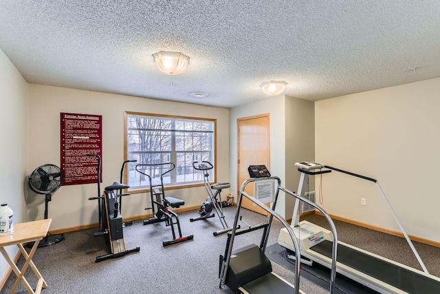 exercise area featuring a textured ceiling