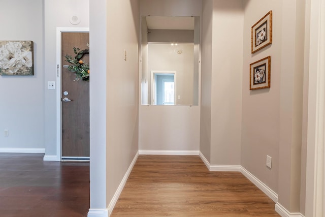 hallway with hardwood / wood-style flooring