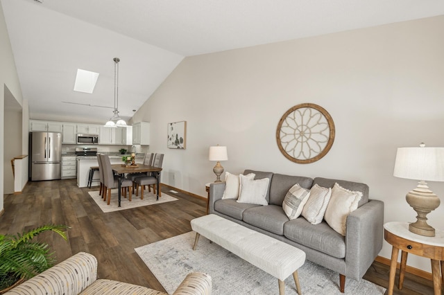 living room featuring dark hardwood / wood-style flooring and lofted ceiling with skylight