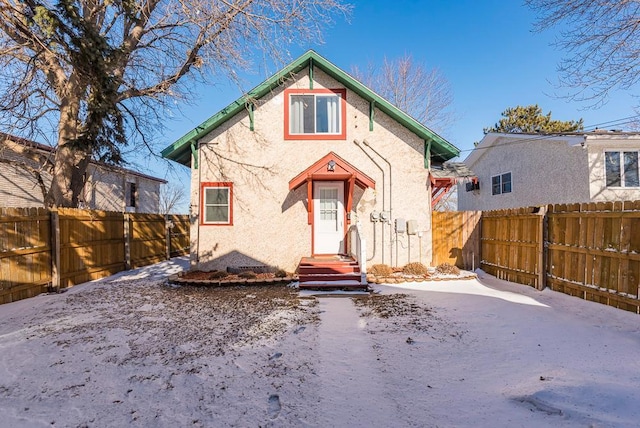 view of front of house featuring fence and stucco siding