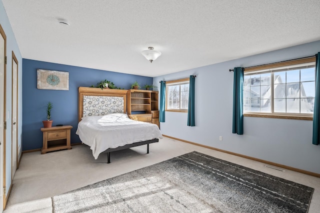 carpeted bedroom with a textured ceiling