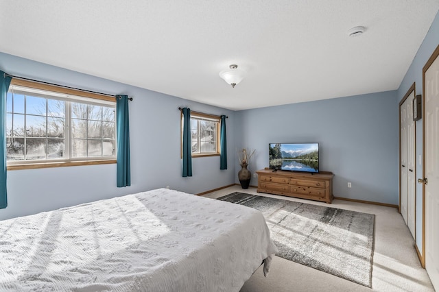 carpeted bedroom featuring multiple windows