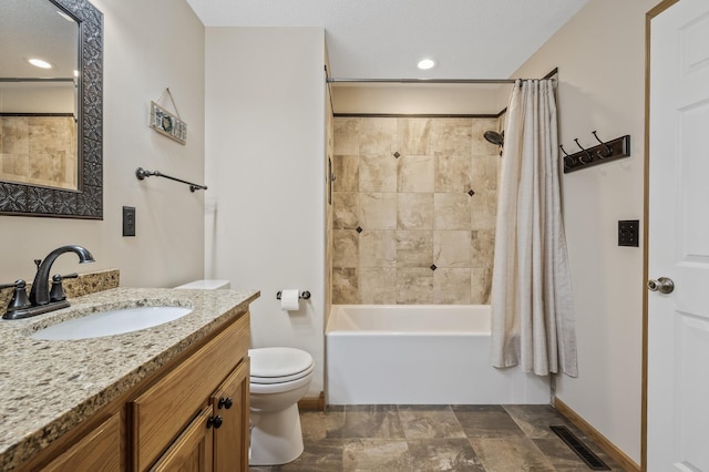 full bathroom with vanity, shower / bath combination with curtain, and toilet