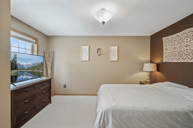 carpeted bedroom featuring a textured ceiling