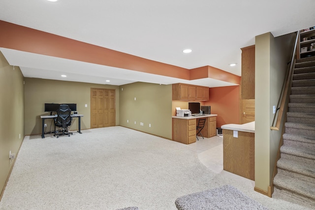 kitchen featuring light colored carpet and kitchen peninsula