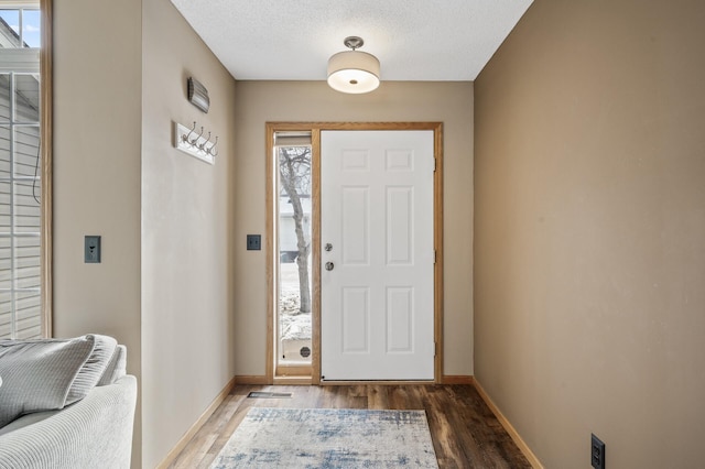 entrance foyer with hardwood / wood-style flooring and a textured ceiling