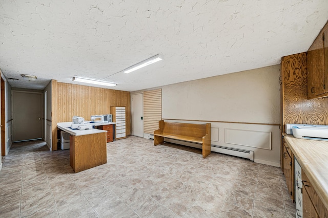 home office featuring a baseboard heating unit and wooden walls