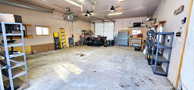 garage featuring a garage door opener and a workshop area